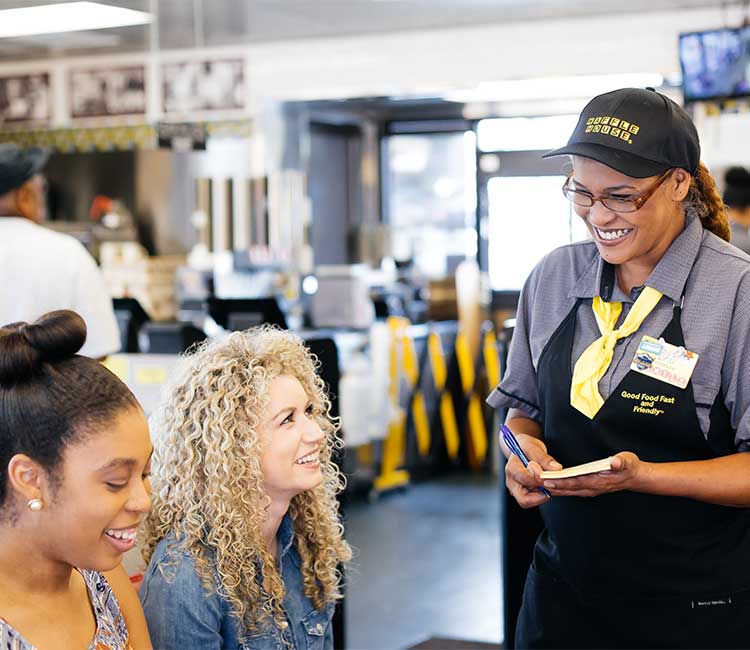 Smiling Waffle House employee taking orders